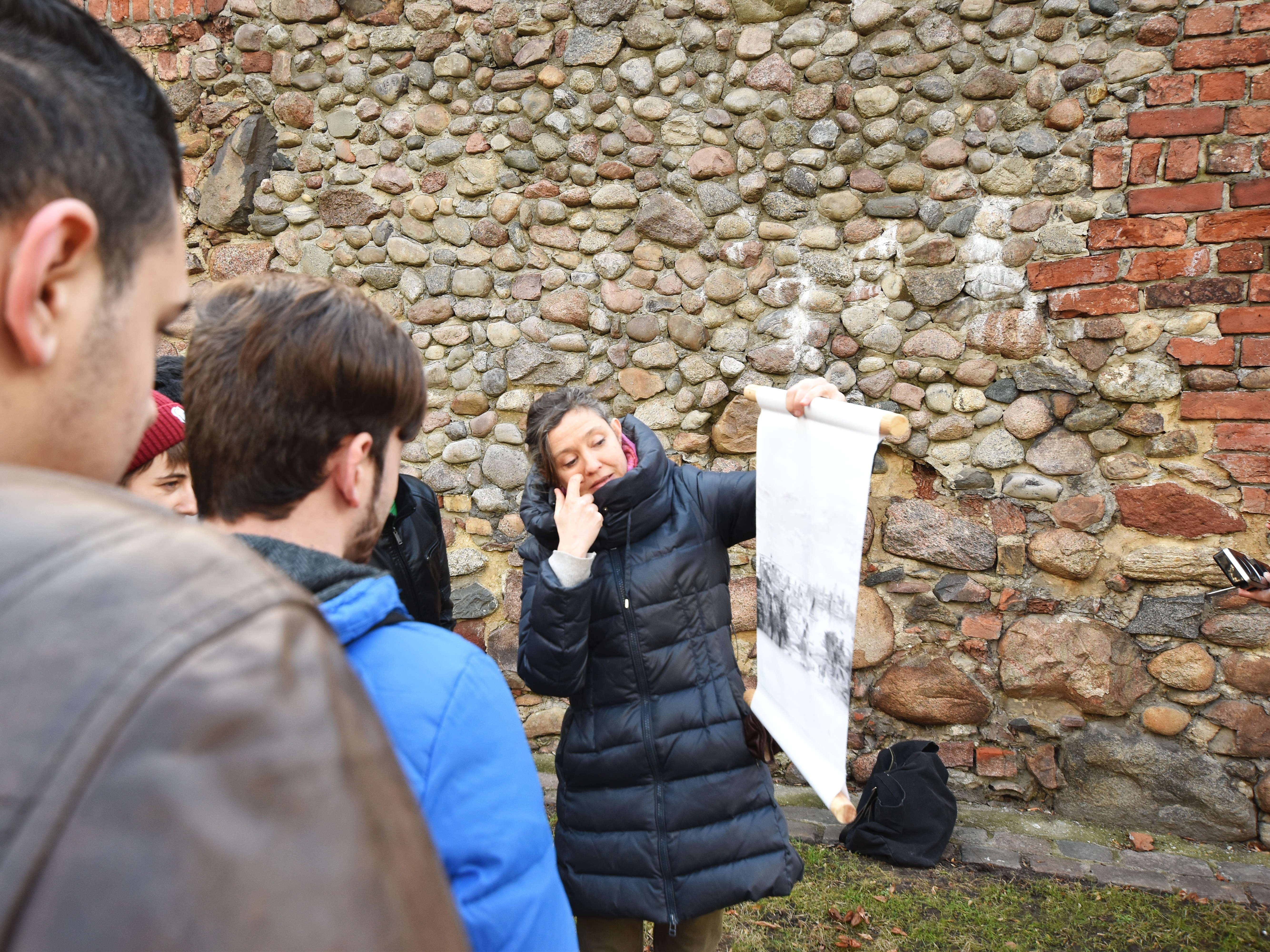 Stadtführungsgruppe vor einem Teil der historischen Stadtmauer (Bild: Mitte Museum)